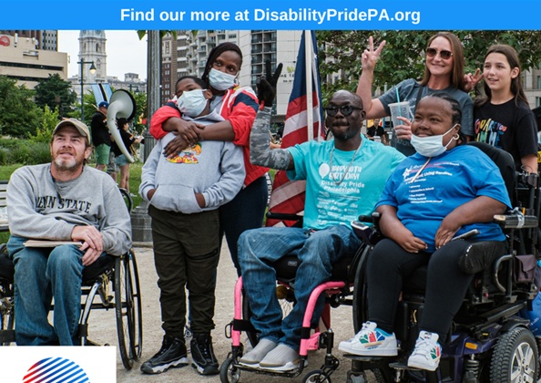 A group of disabled and non-disabled people gathered together to have a photo taken with the city as its backdrop.