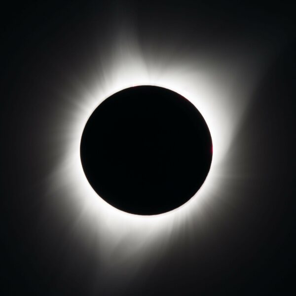 A picture of a full solar eclipse. A ring of light around a dark circle.