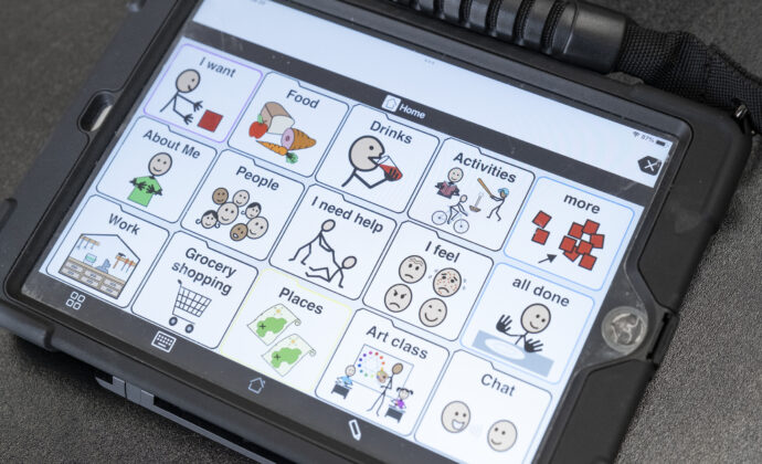 A tablet displaying AAC communication icons