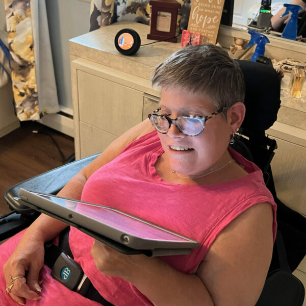 Melanie Yoho at home using her tablet. “This technology makes life easier.”