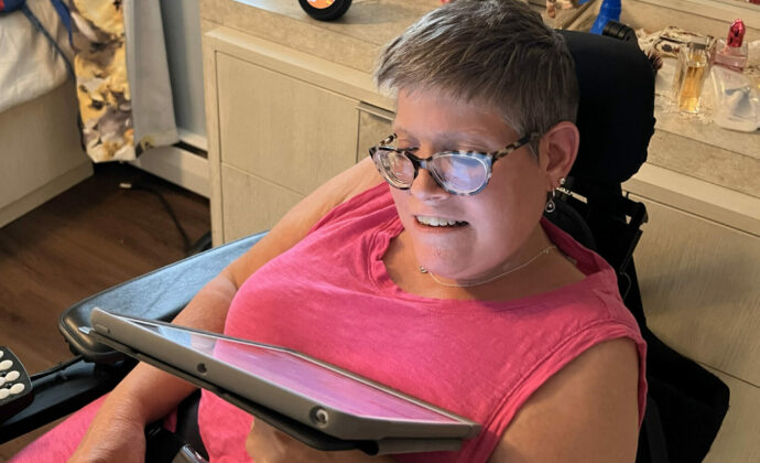 Melanie Yoho at home using her tablet. “This technology makes life easier.”