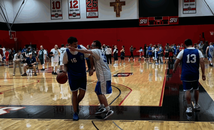 One basket ball player defends another player who is dribbling the ball