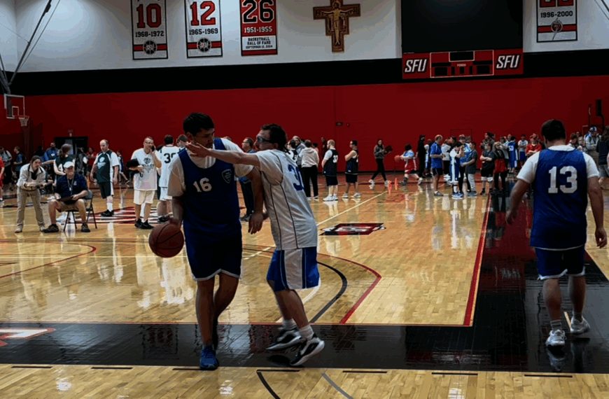 One basket ball player defends another player who is dribbling the ball