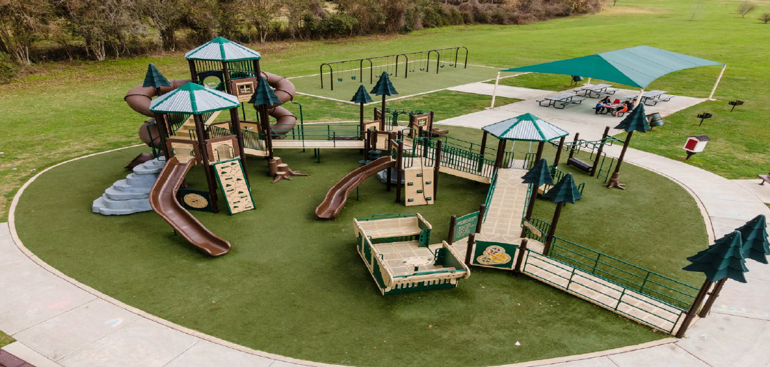 An overhead shot of an inclusive playground in a park.