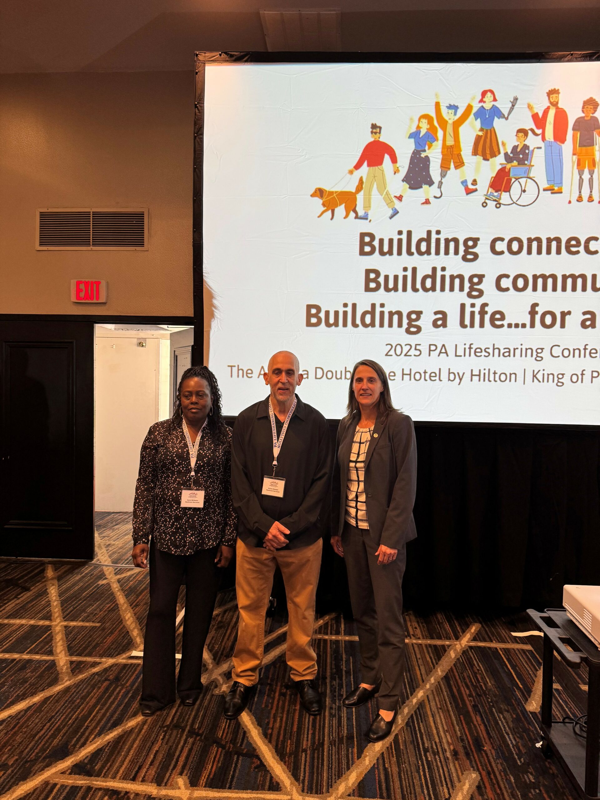 Deputy Secretary Kristin Ahrens poses for a photo with Lifesharing award winners Carol Williams and Arturo Burgos of KenCrest