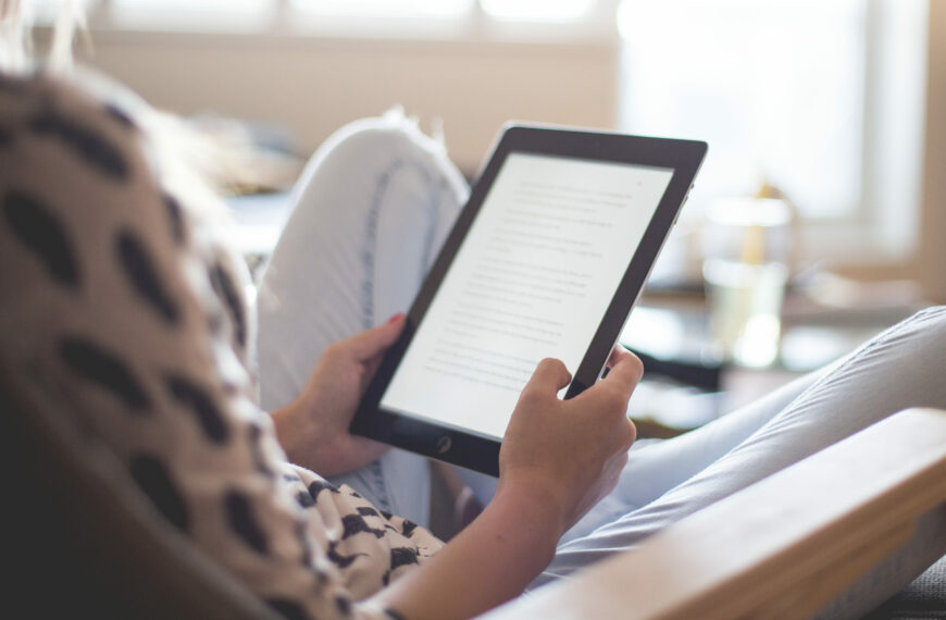 Behind the shoulder of a woman using an ipad