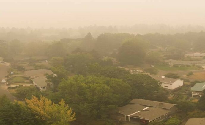 An overview of a PA suburb with hazy orange tinged smoke in the fogging the picture.
