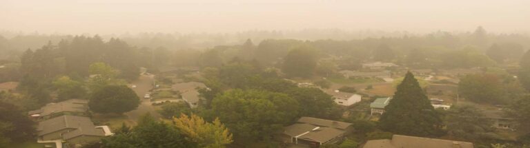 An overview of a PA suburb with hazy orange tinged smoke in the fogging the picture.