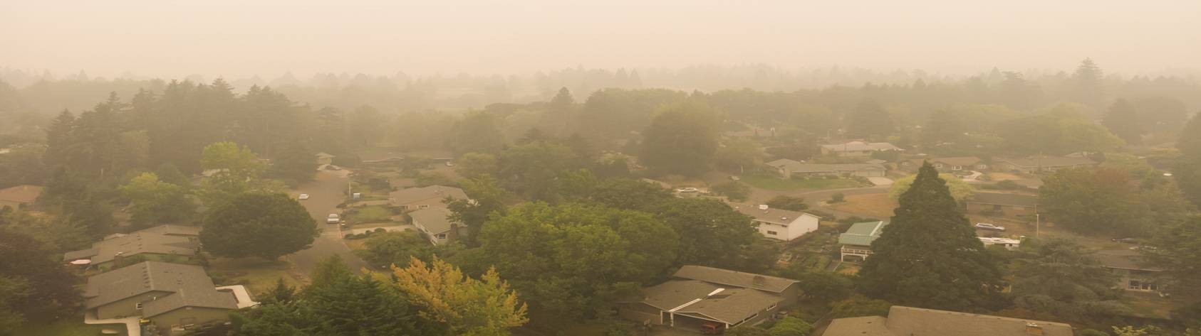 An overview of a PA suburb with hazy orange tinged smoke in the fogging the picture.
