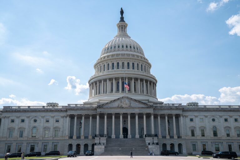 Stunning architectural shot of the US Capitol under a clear blue sky